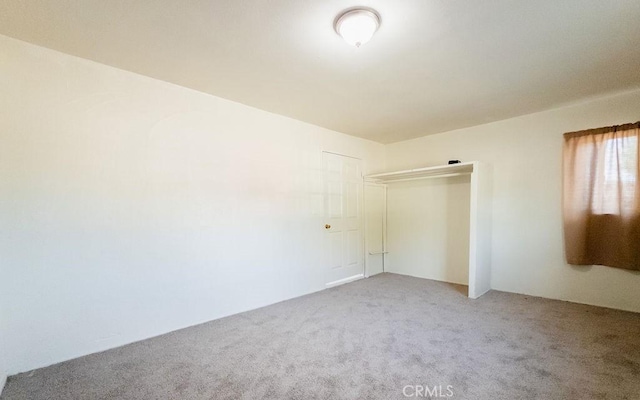 unfurnished bedroom with carpet floors and a closet