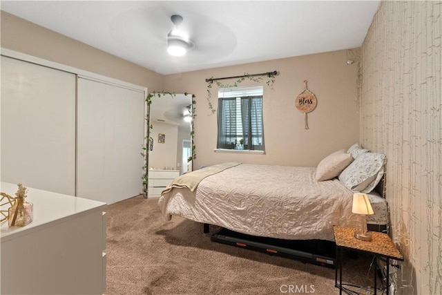 bedroom with ceiling fan, a closet, and carpet