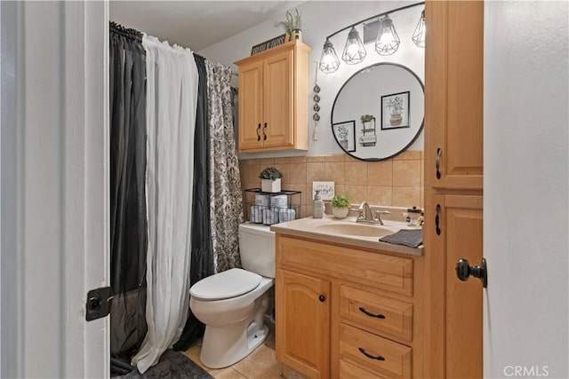 bathroom with tile patterned floors, vanity, toilet, and tasteful backsplash