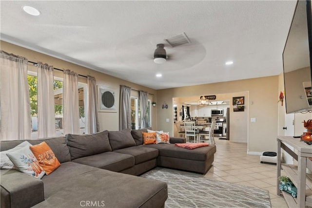 tiled living room with ceiling fan