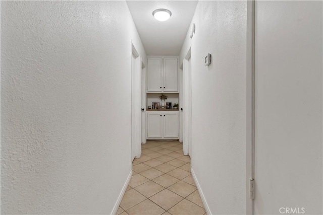 hall featuring light tile patterned flooring