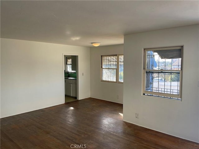 spare room with dark wood-type flooring