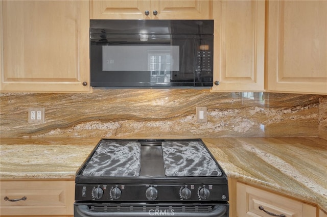 details featuring black appliances, decorative backsplash, and light brown cabinetry