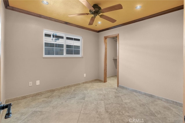 unfurnished room featuring ceiling fan and crown molding