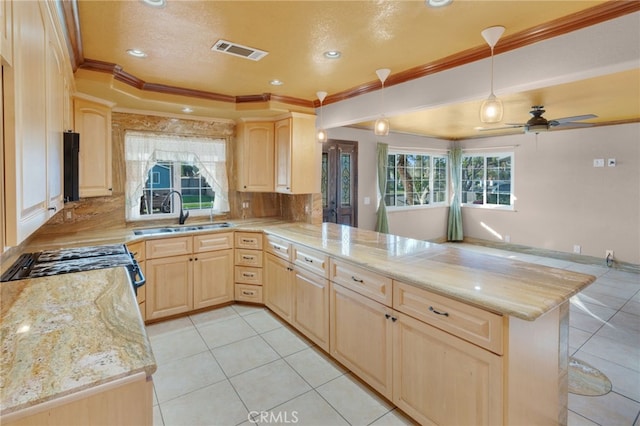 kitchen featuring light brown cabinets, kitchen peninsula, and sink