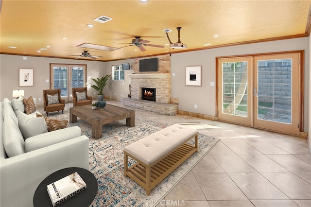 tiled living room with a textured ceiling and a healthy amount of sunlight