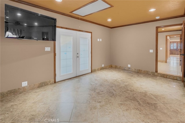 unfurnished room featuring crown molding and french doors