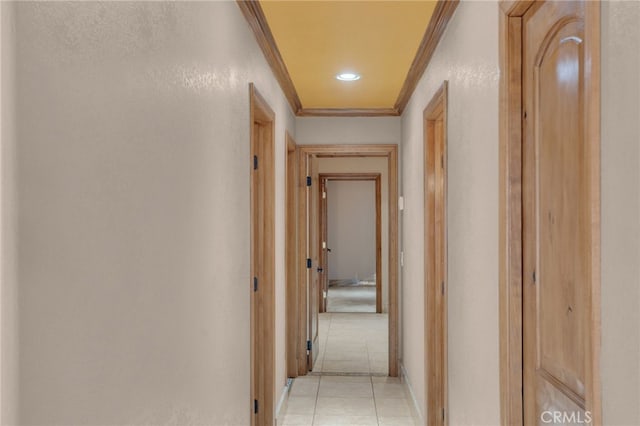 corridor with ornamental molding and light tile patterned floors