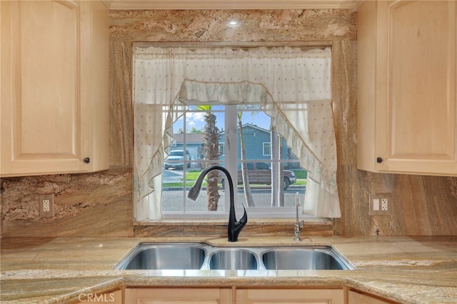 details with decorative backsplash, light brown cabinetry, and sink