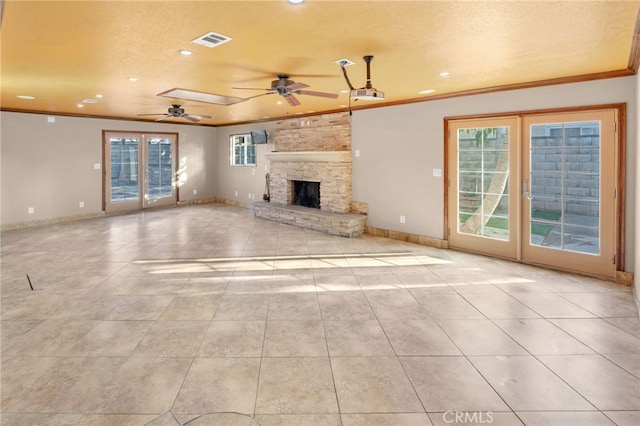 unfurnished living room featuring french doors, plenty of natural light, and a textured ceiling