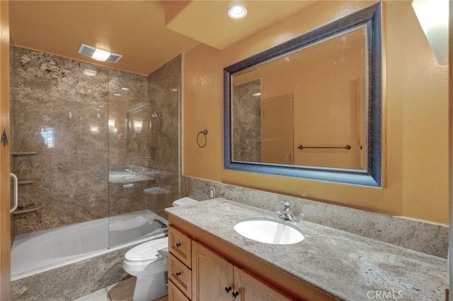 full bathroom with vanity, tiled shower / bath combo, and toilet