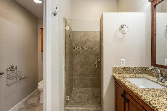 bathroom with vanity, toilet, and walk in shower