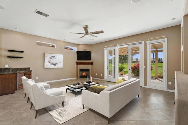 tiled living room featuring ceiling fan