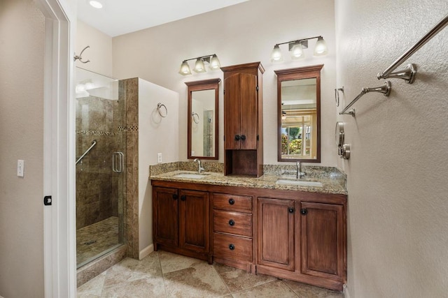 bathroom with tile patterned floors, vanity, and an enclosed shower