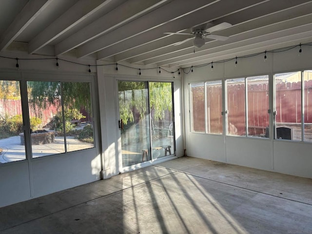 unfurnished sunroom featuring ceiling fan