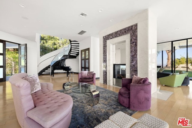 living room with light hardwood / wood-style floors and a fireplace