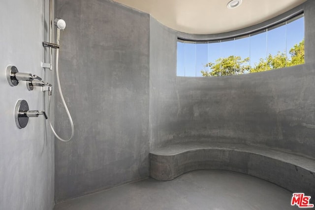 bathroom featuring a shower and concrete floors