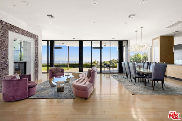 living room featuring expansive windows and light wood-type flooring