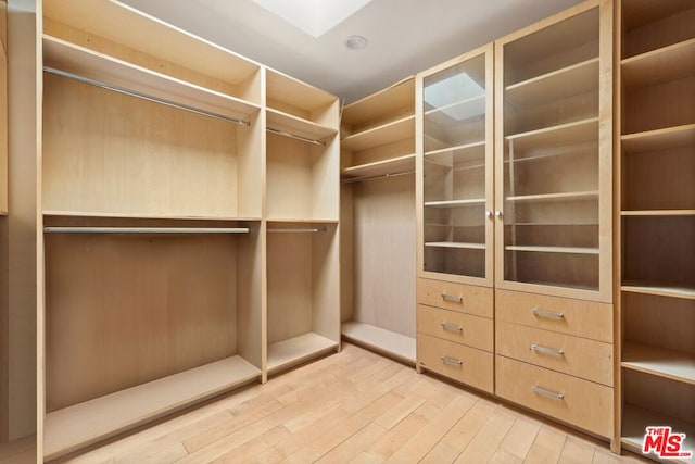 spacious closet featuring light hardwood / wood-style floors