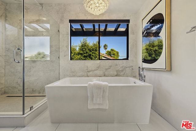 bathroom featuring tile patterned flooring, a notable chandelier, and plus walk in shower