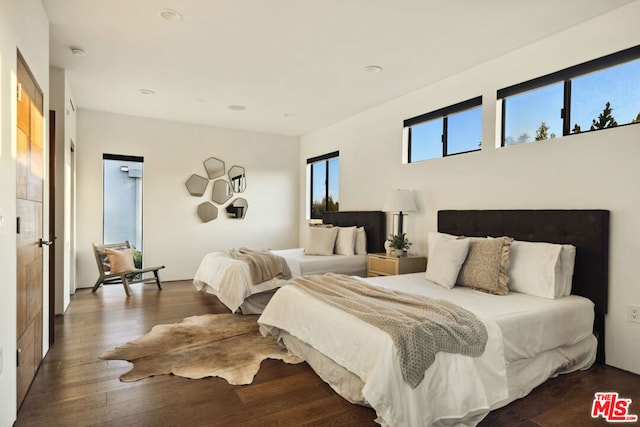 bedroom with dark hardwood / wood-style floors