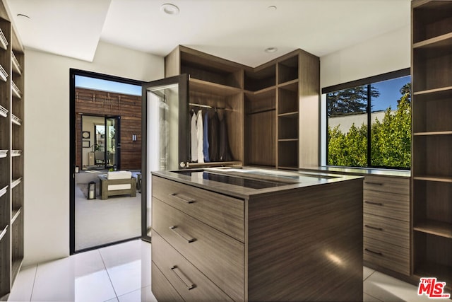 spacious closet featuring light tile patterned flooring