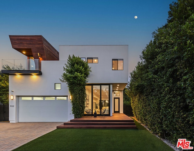 contemporary house with a yard and a garage