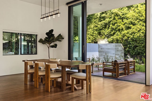 dining space with wood-type flooring