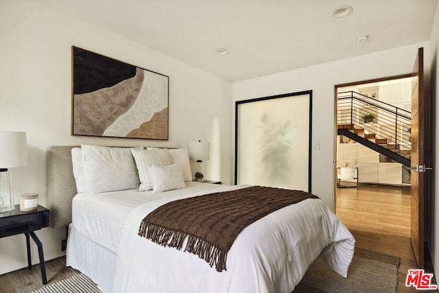 bedroom with wood-type flooring