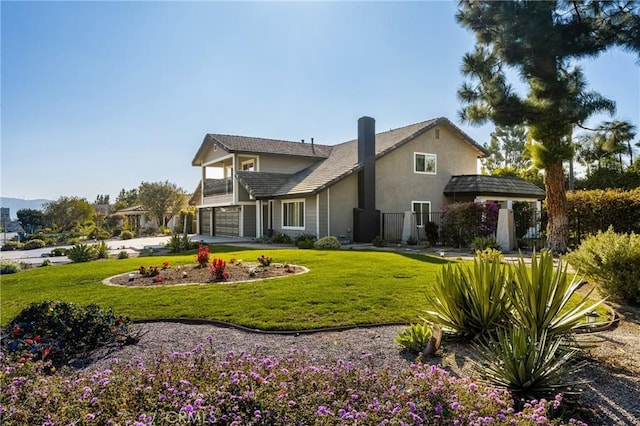 exterior space with a yard, a balcony, and a garage