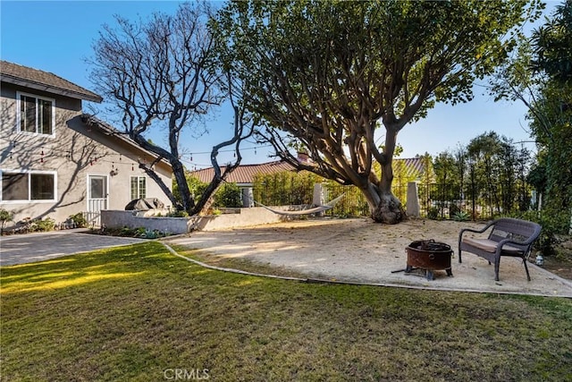 view of yard with an outdoor fire pit