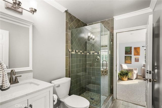 bathroom featuring ornamental molding, vanity, hardwood / wood-style floors, toilet, and a shower with shower door