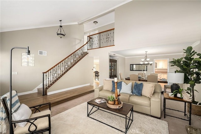 living room with a chandelier, light hardwood / wood-style flooring, and crown molding