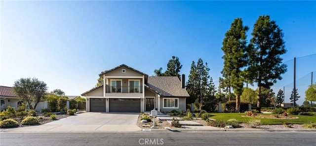 front of property with a garage and a balcony