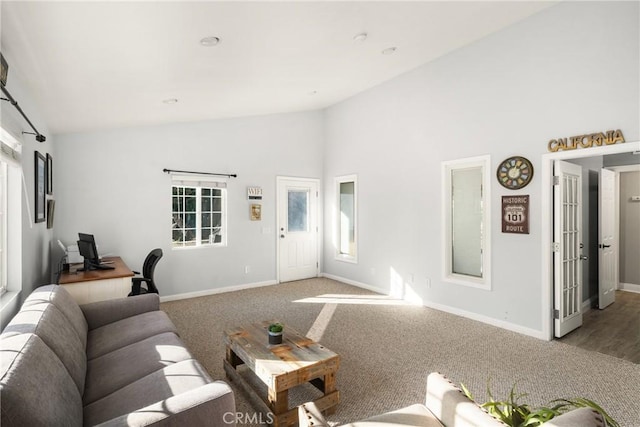 carpeted living room featuring a healthy amount of sunlight and high vaulted ceiling