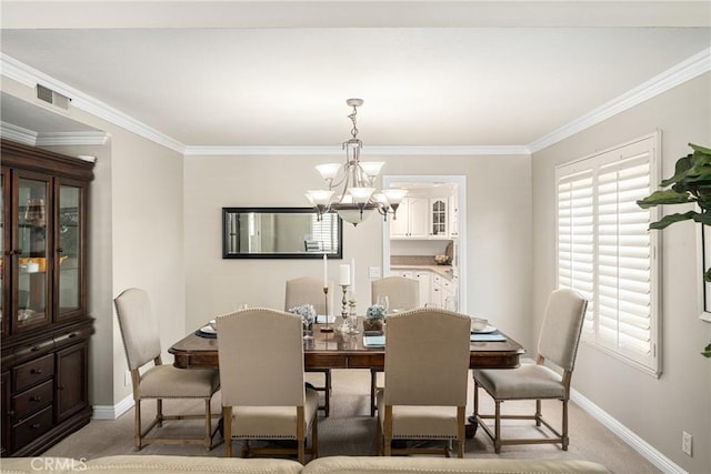 carpeted dining space featuring a chandelier and ornamental molding