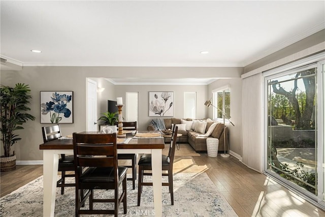 dining area featuring hardwood / wood-style flooring and ornamental molding