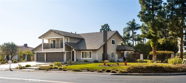 view of front of property with a garage and a balcony