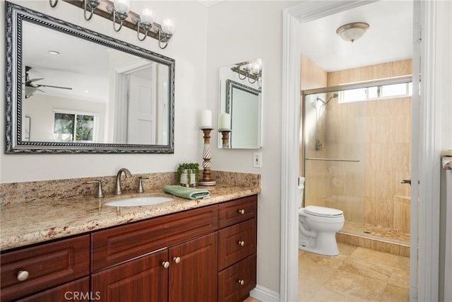 bathroom featuring vanity, a shower with door, toilet, and ceiling fan