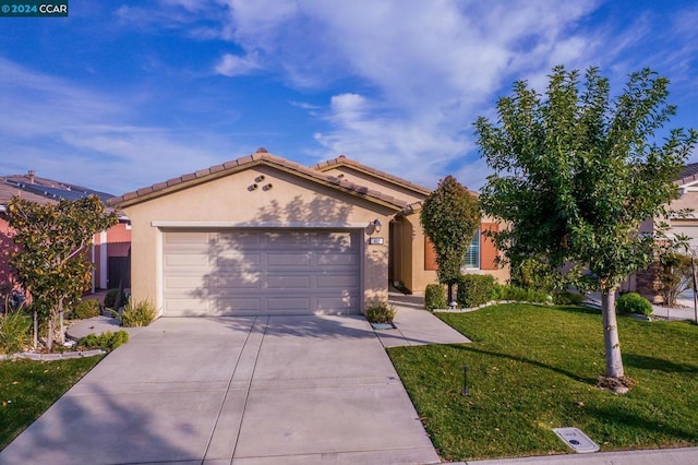 view of front of property featuring a garage and a front yard