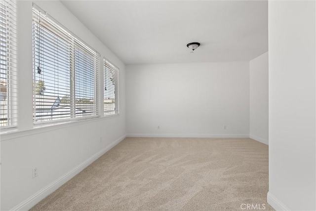 unfurnished room with light colored carpet