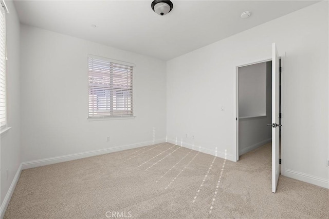 unfurnished bedroom featuring light colored carpet