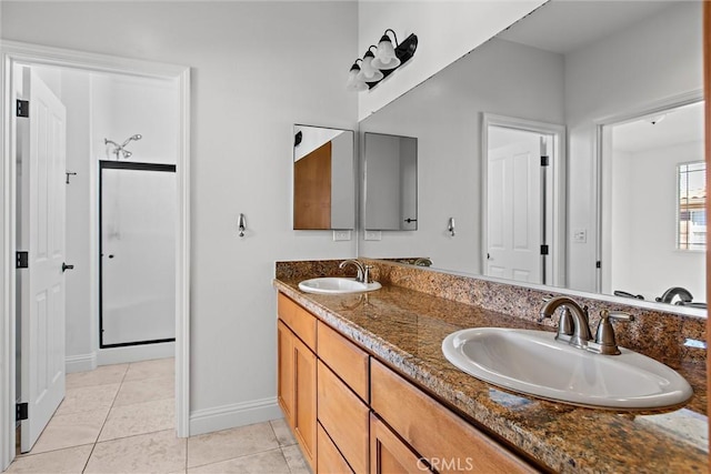 bathroom featuring tile patterned floors, vanity, and a shower with door