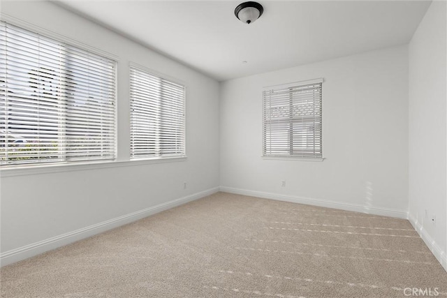 unfurnished room with carpet and plenty of natural light