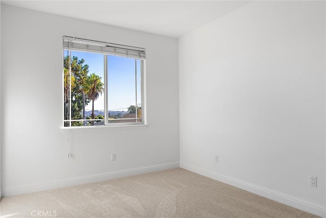 unfurnished room with light colored carpet