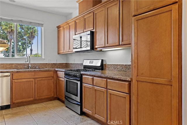 kitchen featuring sink, light tile patterned flooring, and appliances with stainless steel finishes