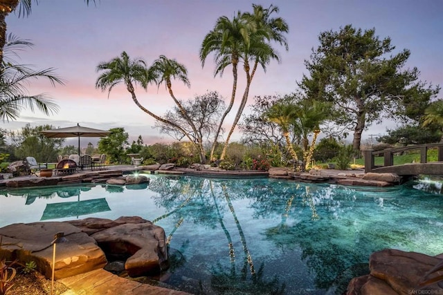 view of pool at dusk