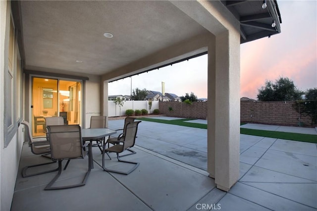 view of patio terrace at dusk