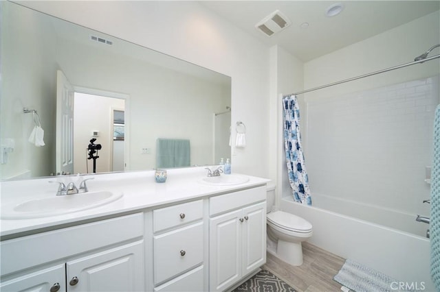 full bathroom with hardwood / wood-style flooring, vanity, toilet, and shower / bathtub combination with curtain