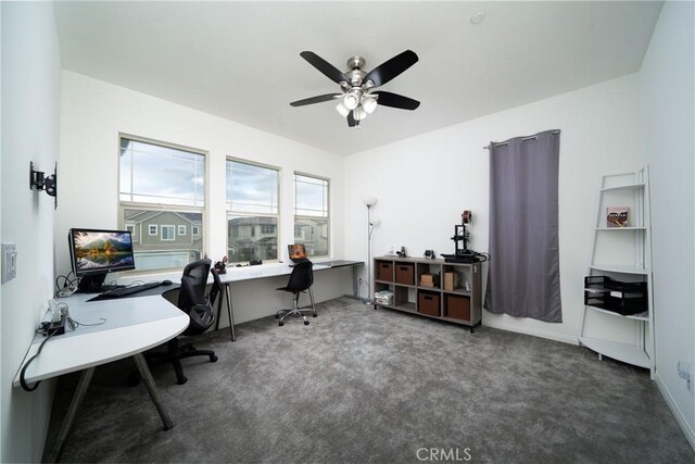 office with dark colored carpet and ceiling fan